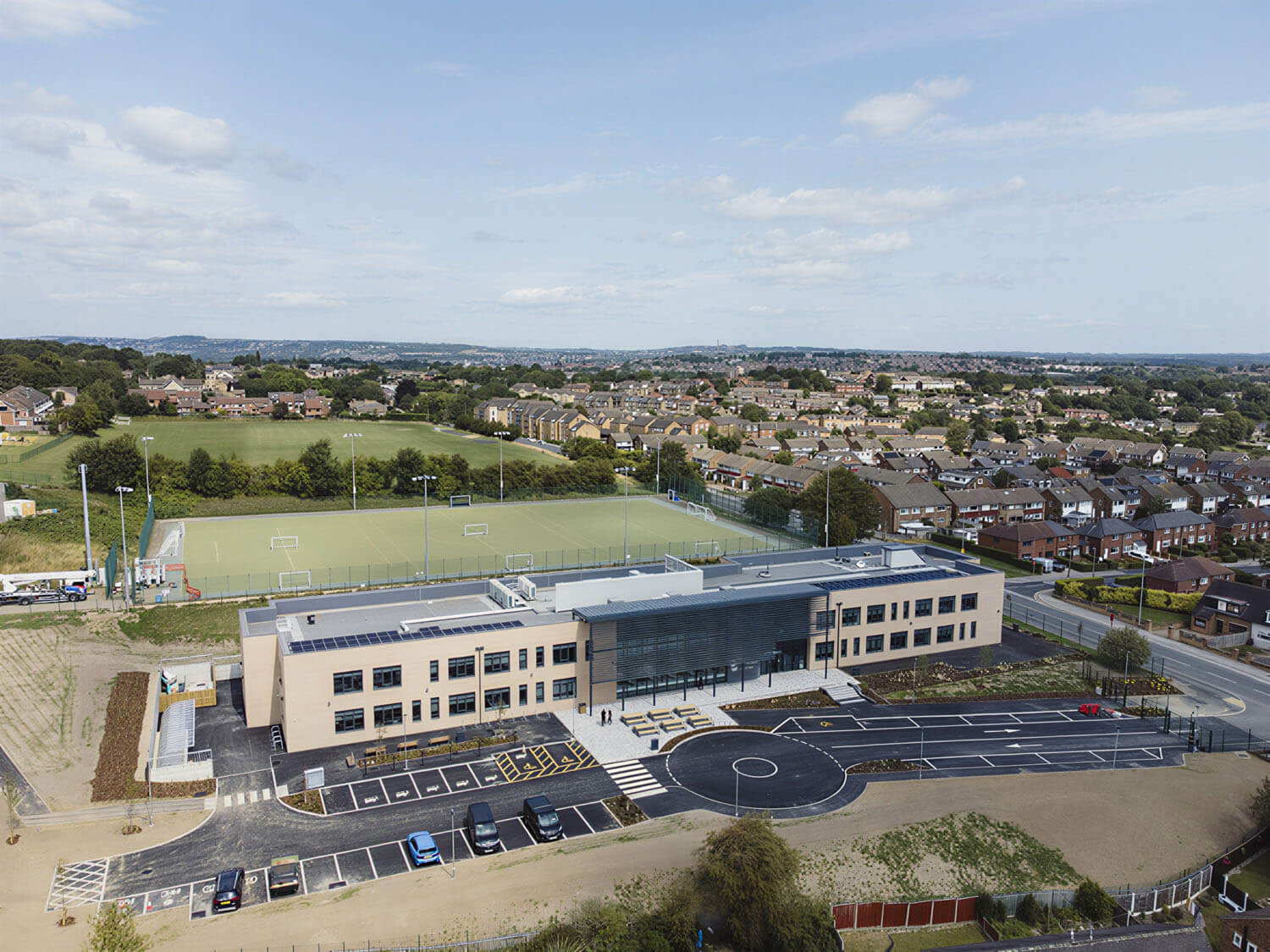 Pudsey Sixth Form College from above with rooftop solar panels across the main roof. Building performance by CAD21