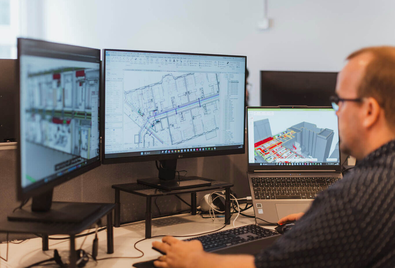 CAD21 Digital and Tech services team member at computer using modelling software